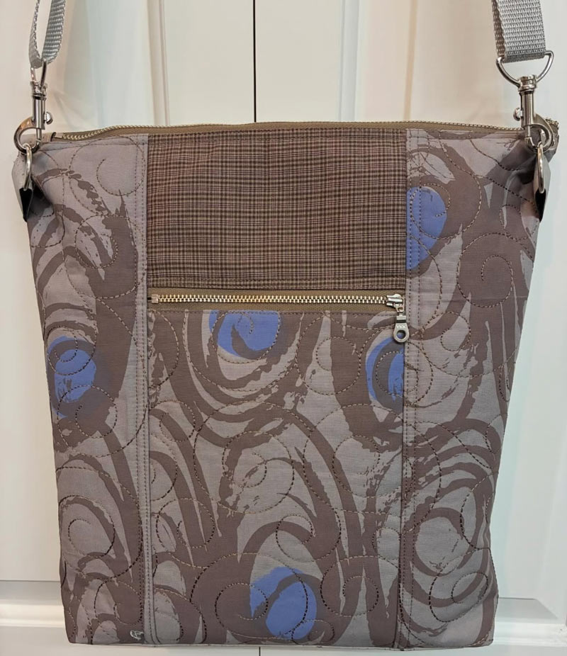 Patterned handbag with a visible zipper on a white background